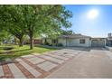 Attractive home featuring a well-maintained lawn, mature trees, and a decorative driveway at 5812 N 18Th Pl, Phoenix, AZ 85016