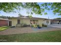 Inviting front yard with yellow Adirondack chairs on a paved patio, perfect for relaxing at 5812 N 18Th Pl, Phoenix, AZ 85016