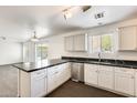 Kitchen features white cabinets, stainless steel appliances, and a view into the living area at 6830 W Desert Ln, Laveen, AZ 85339