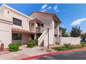 Attractive condo building with a red tile roof, lush landscaping, and inviting stairways to the upper units at 7800 E Lincoln Dr # 2092, Scottsdale, AZ 85250