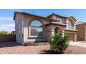Two-story home with desert landscaping, arched windows, and neutral-toned stucco siding at 9662 W Sunnyslope Ln, Peoria, AZ 85345