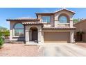 Two-story home with desert landscaping, arched windows, and a two car garage at 9662 W Sunnyslope Ln, Peoria, AZ 85345