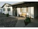 Inviting covered front porch with decorative plants and a bench for enjoying the neighborhood at 1217 N 78Th St, Scottsdale, AZ 85257