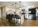 Modern kitchen featuring white cabinets, stainless steel appliances, and a kitchen island with bar seating at 1217 N 78Th St, Scottsdale, AZ 85257