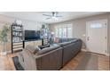 Comfortable living room featuring a large sectional sofa, wood flooring, and a bright window with stylish decor at 1217 N 78Th St, Scottsdale, AZ 85257