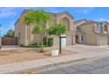Two story home featuring a two car garage, neutral exterior paint, and desert landscaping at 12841 W W . Via Camille --, El Mirage, AZ 85335