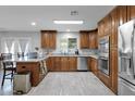 Spacious kitchen with custom cabinets, stainless steel appliances, granite countertops, and tile flooring at 12841 W W . Via Camille --, El Mirage, AZ 85335
