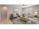 Comfortable living room with a neutral color palette, decorative rug and lots of natural light at 18801 W Yucatan Dr, Surprise, AZ 85388