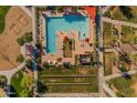 Overhead perspective of the community pool features lounge areas, sunshades, and well-manicured lawns at 22891 E Via Del Sol --, Queen Creek, AZ 85142