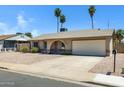 Charming single-story home with low maintenance gravel front yard, arched entry, and attached two car garage at 2305 E Glade Ave, Mesa, AZ 85204