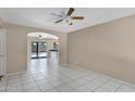 Bright, open living space with tile flooring and a seamless flow to the kitchen and outdoor pool area at 2305 E Glade Ave, Mesa, AZ 85204