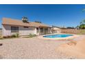 Home backyard with an above ground pool, desert landscaping, partial patio, and fencing at 2509 N Cheri Lynn Dr, Chandler, AZ 85225