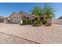 Traditional home with neutral siding, desert landscaping, a long driveway, and an attached two car garage at 2509 N Cheri Lynn Dr, Chandler, AZ 85225