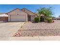 A charming single-story home with a well-maintained lawn and an attached two car garage, and desert landscaping at 2509 N Cheri Lynn Dr, Chandler, AZ 85225