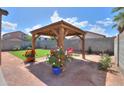 Backyard featuring artificial grass and a gazebo at 45475 W Guilder Ave, Maricopa, AZ 85139