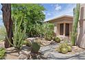 Landscaped front yard with desert plants and a walkway to the home at 6714 E Amber Sun Dr, Scottsdale, AZ 85266