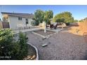 Expansive backyard with mature trees, patio seating, and stone landscaping, creating a relaxing outdoor space at 8025 E Medina Ave, Mesa, AZ 85209