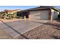 Inviting home featuring a spacious driveway, well-kept landscaping, and an attached two-car garage at 8025 E Medina Ave, Mesa, AZ 85209