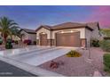 Well-maintained home with a three-car garage, desert landscaping, and an extended driveway at 1019 N Tambor Cir, Mesa, AZ 85207