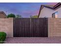 Rustic privacy gate with sturdy brick pillars, providing security and aesthetic appeal to the property at 1019 N Tambor Cir, Mesa, AZ 85207
