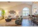 Open-concept living room with vaulted ceilings, stylish decor, and a view of the breakfast bar at 11447 N 109Th St, Scottsdale, AZ 85259