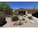 Attractive house featuring desert landscaping, including rocks, and various arid plants at 18436 W Shasta St, Goodyear, AZ 85338