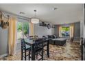 The dining and living area features tile floors, ample natural light, and neutral wall colors at 21033 N Alexis Ave, Maricopa, AZ 85138