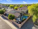 Aerial view showing the backyard oasis with pool, gazebo, lush landscaping and solar panels on the roof at 32881 N Hidden Canyon Dr, San Tan Valley, AZ 85144