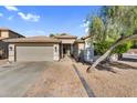 Charming front exterior features a brick-paved driveway and a well-maintained two-car garage at 32881 N Hidden Canyon Dr, San Tan Valley, AZ 85144