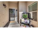 Inviting front porch with a decorative wreath, welcome sign, and bench adds a cozy touch at 32881 N Hidden Canyon Dr, San Tan Valley, AZ 85144