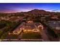 Expansive aerial view of a luxury estate home with mountain views, lush landscaping, and neighborhood surroundings at 3981 E Runaway Bay Pl, Queen Creek, AZ 85142