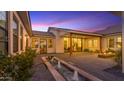 Serene backyard featuring a modern fountain, brick-paved patio, and cozy fire pit lounge area at 3981 E Runaway Bay Pl, Queen Creek, AZ 85142