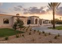 Sweeping view of the property, displaying the well-maintained landscape and attractive architectural design against a colorful sky at 6633 E Horseshoe Rd, Paradise Valley, AZ 85253