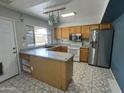 Kitchen with a center island, tile flooring, and stainless steel appliances at 12836 N 39Th Ln, Phoenix, AZ 85029