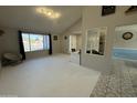 Bright living room features neutral tones, a large window, and an open floor plan at 12836 N 39Th Ln, Phoenix, AZ 85029