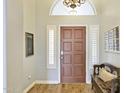 Welcoming entryway featuring a dark wooden door, light grey walls, and elegant decorative touches at 2431 E Laurel St, Mesa, AZ 85213