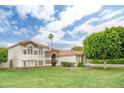 Beautiful stucco home with red tile roof, stone accents, and a large lawn at 2431 E Laurel St, Mesa, AZ 85213