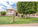 Attractive home with stone detailing, a red tile roof, and a well-manicured lawn and a 'For Sale' sign at 2431 E Laurel St, Mesa, AZ 85213