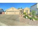 Charming single-story home boasting a three-car garage and low maintenance desert landscaping at 329 S Marin Dr, Gilbert, AZ 85296