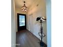 Foyer with hardwood floors, decorative door, and hat rack at 3800 E Lincoln Dr # 37, Phoenix, AZ 85018