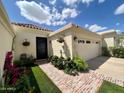 Inviting front entrance with decorative door, beautiful brick walkway, and lush landscaping at 3800 E Lincoln Dr # 37, Phoenix, AZ 85018