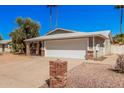 Charming single-story home features brick accents, a two-car garage, and low-maintenance landscaping at 4305 N 101St Ave, Phoenix, AZ 85037