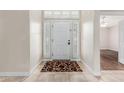 Bright foyer with neutral tile flooring, leading into a spacious living area, with the front door at 4620 E Desert Cactus St, Phoenix, AZ 85032