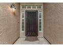 Close-up of secure front door with decorative security screen, sidelights, and overhead window at 4620 E Desert Cactus St, Phoenix, AZ 85032