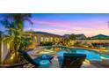 Inviting pool and spa area featuring comfortable lounge chairs under a gorgeous sunset at 4865 S Cylinder Way, Mesa, AZ 85212