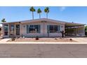 Exterior view showing desert landscaping, covered carport, and lovely curb appeal at 661 S Hawes Rd # 81, Mesa, AZ 85208