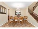 Spacious dining room with modern light fixture, large mirror, staircase, and elegant decor at 882 E Parkview Dr, Gilbert, AZ 85295
