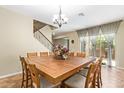 Dining room features a large square table, wood chairs, stairs, and bright windows at 882 E Parkview Dr, Gilbert, AZ 85295