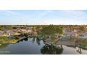 An aerial view captures homes with waterfront access, lush landscaping, private docks, and scenic water views at 1267 E Chicago Cir, Chandler, AZ 85225