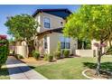 Charming home with a well-manicured lawn and mature trees, offering shade and curb appeal at 15387 W Columbine Dr, Surprise, AZ 85379